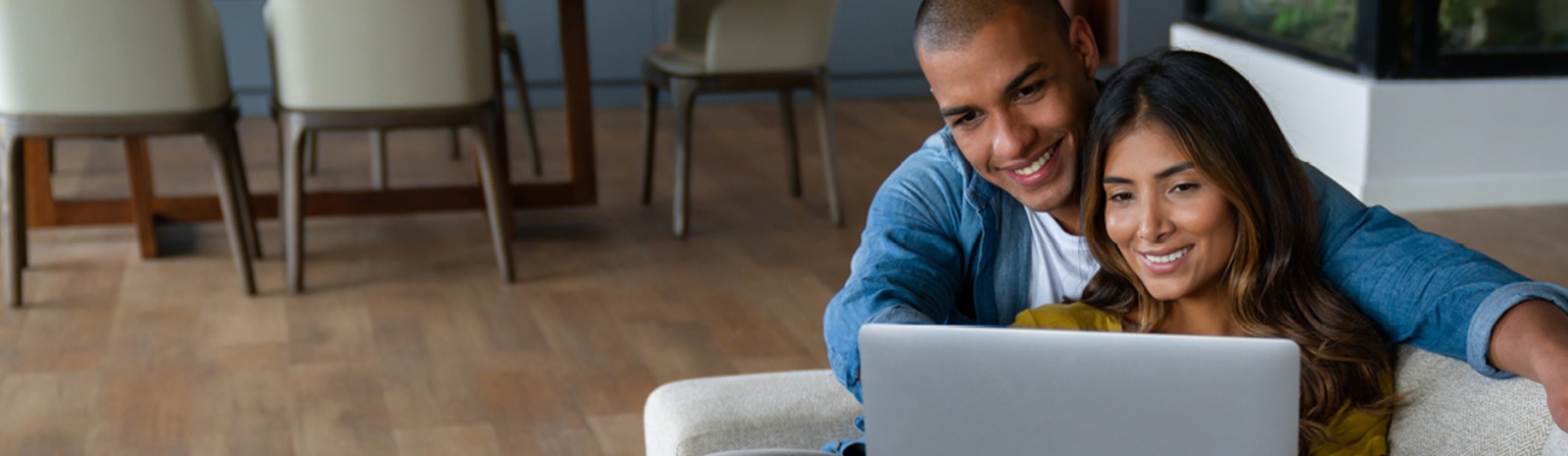 a couple looking at their laptop computer
