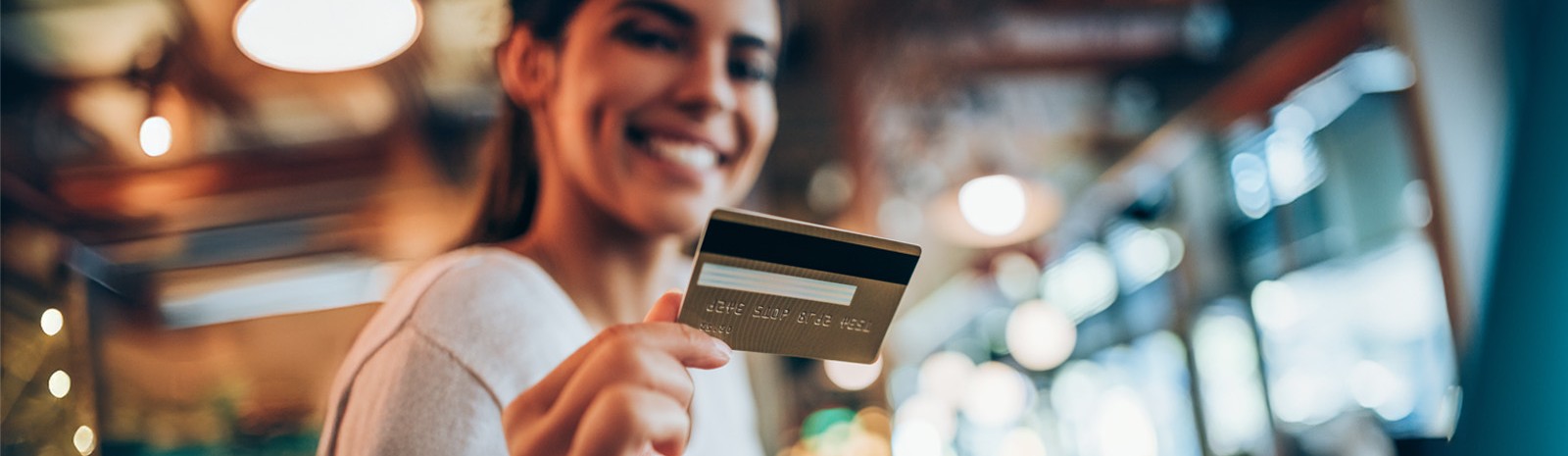 a woman holding a credit card